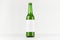 Green longneck beer bottle 500ml with blank white label on white wooden board, mock up.