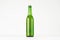 Green longneck beer bottle 500ml, mock up. Template for advertising, design, branding identity on white wood table.