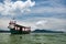 Green Longtail boat moored in Saracen Bay in Koh Ron Samloem, Cambodia