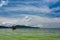 Green Longtail boat moored in Saracen Bay in Koh Ron Samloem, Cambodia