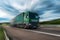 Green Lorry truck speeding on freeway at sunset