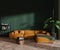 Green lounge zone interior with couch and coffee table. Mockup wall