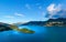 Green lush Forest peninsula on Lake Wakatipo with Southern Alps mountains in the background, aerial view at sunset