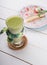 Green macha tea glass served with cheese cake served on wooden board