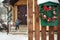 Green mailbox with christmas wreath on a wooden fence. Snow day Home decoration