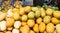 Green mangoes lying on a market counter. Exotic fruits of Asia