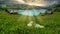 Green meadow by a lake in the mountains at sunset in the French Alps in France