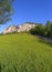 green meadow, mountain and blue sky