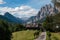 Green Meadow and Typical Houses among Mountains Scenery in Summe