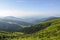 Green meadows and forests in summer Carpathian mountains