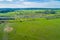 Green meadows and pastures with highway passing through.