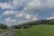 Green meadows in spring sunny cloudy day near Branna town in Jeseniky mountains