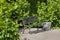 Green metal bench, peaceful resting place.