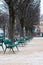 Green metal chairs in the garden in winter season