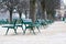 Green metal chairs in the garden in winter season