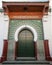 Green metal gate with decoration. Ancient mosque in Medina. Tang