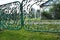 Green metal gate with a wicket - fence garden