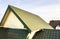 Green metal shingled house roof top