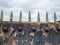 Green metal spikes against the sky on top of a metal barrier