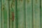 Green metal texture of a striped iron rusty wall