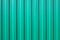 Green metal vertical fence as background