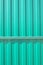 Green metal vertical fence as background