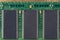 Green microchip of old computer random access memory with black microcircuits, top view