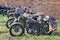 Green military motorcycles parked in a row