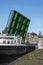 Green modern drawbridge with big boat under it