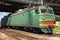 Green modern Russian locomotive with red stripes on cabin