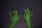 Green monster hands with sharp black nails, body-art