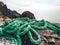 The green mooring line lies on the rocks