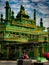 a green mosque full of ornaments on the side of the main road in the north coast of Indramayu, Indonesia