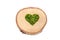 A green moss-filled heart on a birch wood slice