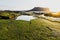 Green mossy stones at sunrise at Ilchulbong volcano crater, Seongsan, Jeju Island, South Korea