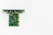 Green motherboard with transistors on a white background