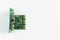 Green motherboard with transistors on a white background