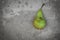 Green mottled pear on concrete background