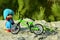 Green mountain bike and small doll in a blue clothes
