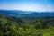 Green mountain top under an Asian blue sky