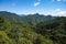 Green mountain top under an Asian blue sky