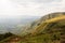 Green mountainous landscape with partially clouded sky