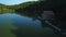 Green mountains reflections on blue quiet lake.