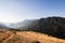 Green mountains with yellow grass fields and lake in the background. Barrea lake seen from the Marsicano mountain in Abruzzo in e