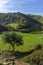 Green mountains in Zumaia under blue sky