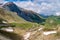 Green mountainsides with snow patches along Grossglockner High Alpine Road, Austria