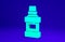 Green Mouthwash plastic bottle and glass icon isolated on blue background. Liquid for rinsing mouth. Oralcare equipment