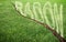 A green mowed lawn with a diagonal crack with radon gas escaping - concept image with copy space
