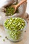 Green mung bean sprouts in bowl and hessian bag with seeds