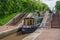 Green Narrowboat leaves a lock chamber